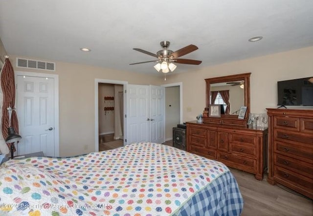 bedroom with light hardwood / wood-style flooring and ceiling fan