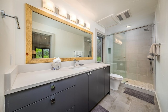 bathroom featuring vanity, toilet, and a shower with door