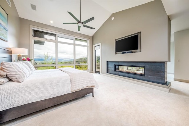 bedroom featuring ceiling fan, carpet, and lofted ceiling