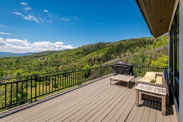 wooden deck featuring a mountain view and grilling area