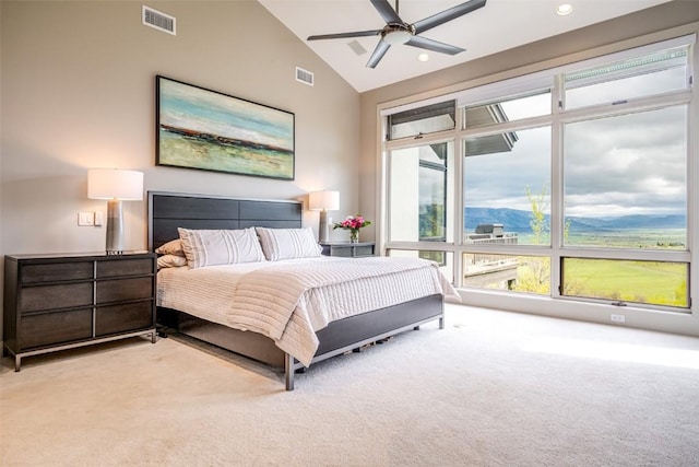 carpeted bedroom featuring ceiling fan, high vaulted ceiling, and a mountain view