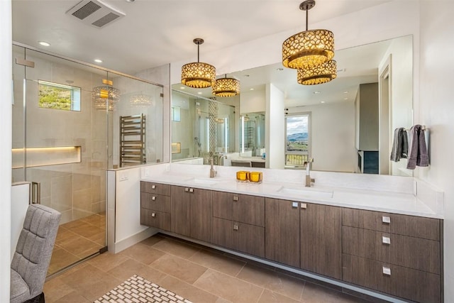 bathroom with radiator, a wealth of natural light, and a shower with shower door