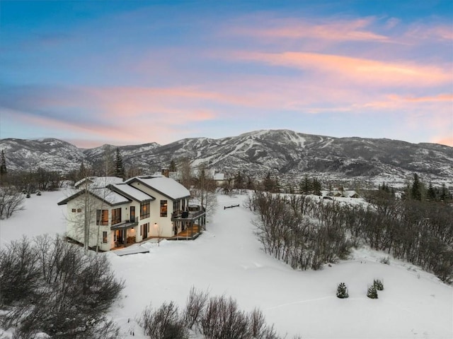 snowy aerial view with a mountain view