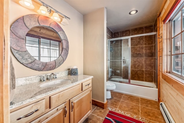 bathroom featuring tile patterned flooring, toilet, combined bath / shower with glass door, vanity, and a baseboard radiator