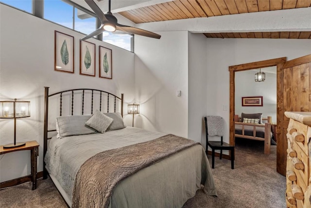 bedroom with vaulted ceiling with beams, ceiling fan, and carpet flooring