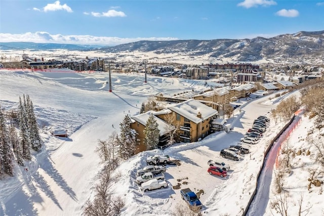 snowy aerial view featuring a mountain view