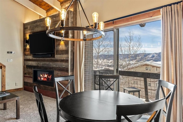 dining area featuring lofted ceiling with beams, a mountain view, and plenty of natural light