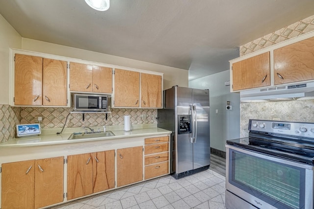 kitchen featuring appliances with stainless steel finishes, backsplash, and sink