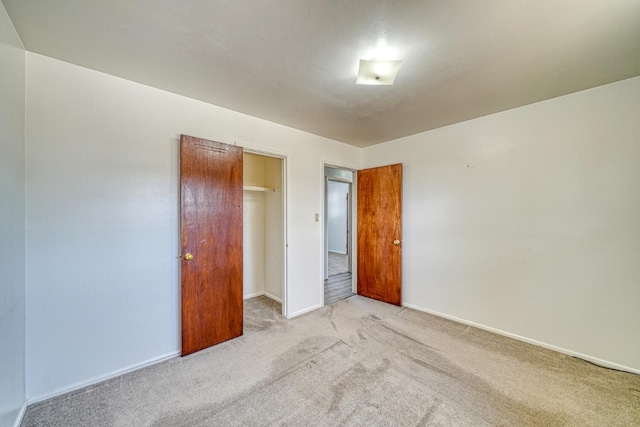 spare room featuring light colored carpet