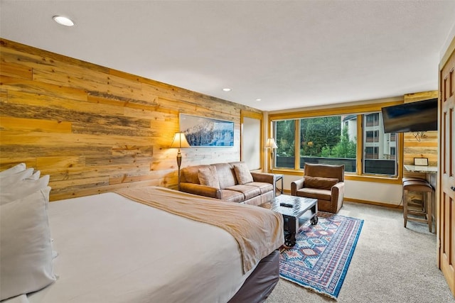 carpeted bedroom featuring wood walls