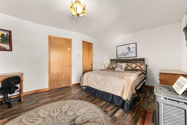 bedroom with dark hardwood / wood-style floors