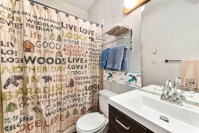 bathroom featuring vanity, a shower with shower curtain, and toilet