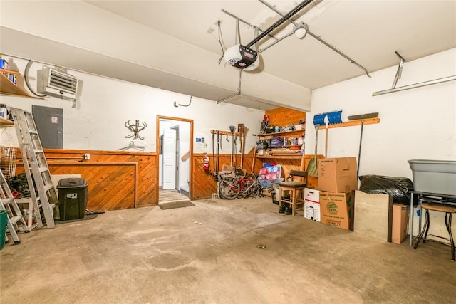 garage featuring electric panel and a garage door opener