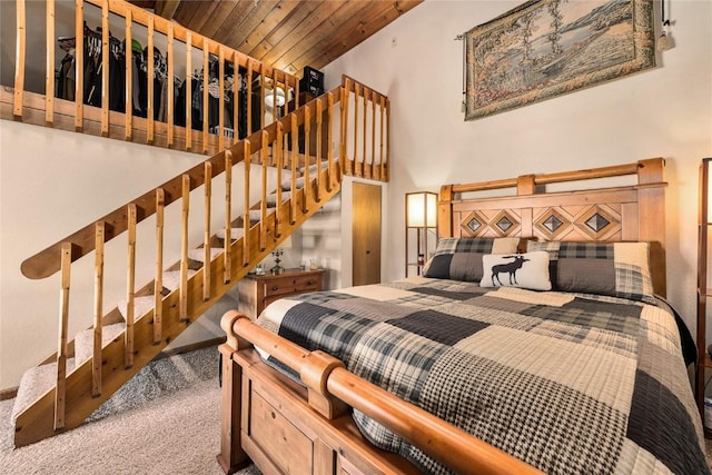 carpeted bedroom with wood ceiling