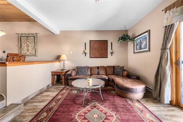 living room with beam ceiling and light hardwood / wood-style floors