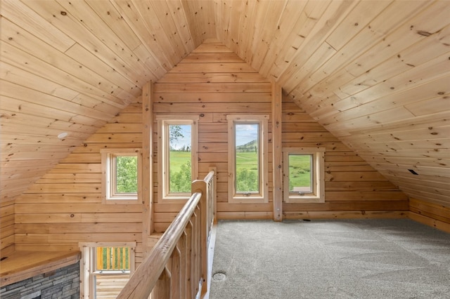 bonus room featuring light colored carpet, vaulted ceiling, wooden ceiling, and wood walls