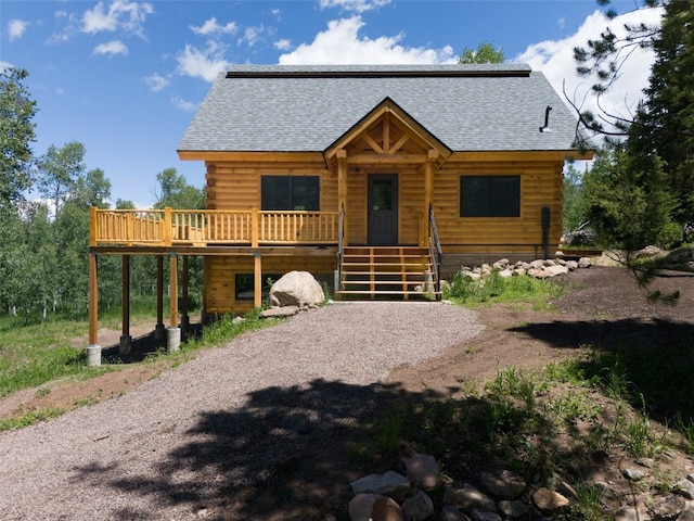 log cabin with a wooden deck