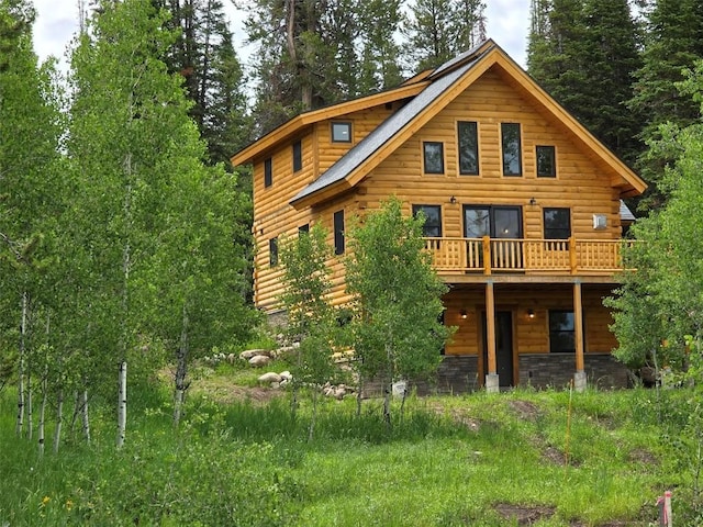 rear view of house featuring a wooden deck