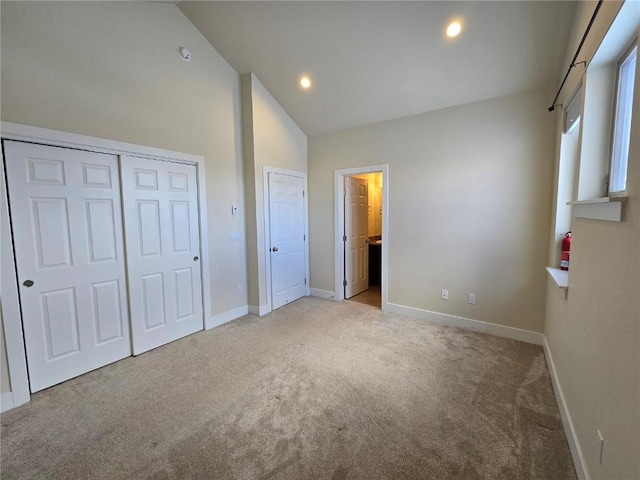 unfurnished bedroom featuring light carpet, high vaulted ceiling, baseboards, and recessed lighting