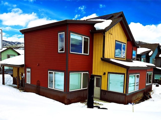 view of snowy exterior with board and batten siding