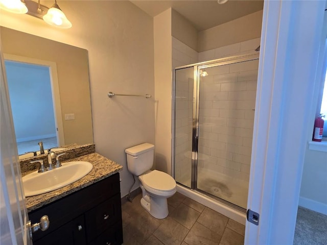 bathroom with a stall shower, baseboards, toilet, tile patterned floors, and vanity