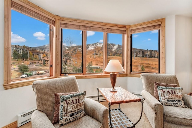 sunroom featuring baseboard heating and a mountain view