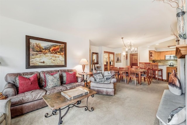 carpeted living room with a chandelier