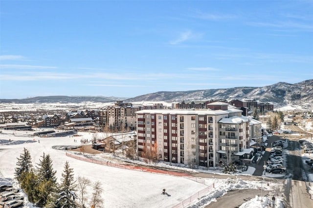 snowy aerial view featuring a mountain view