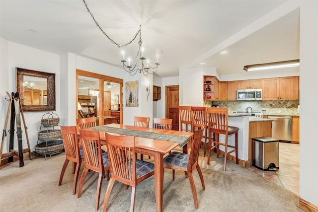 carpeted dining area featuring a chandelier