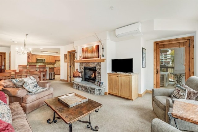 living room featuring a fireplace, light carpet, an inviting chandelier, and an AC wall unit