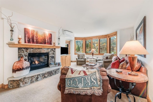 carpeted living room featuring a wall unit AC and a stone fireplace