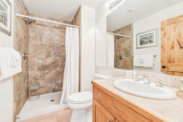 bathroom featuring tile patterned floors, vanity, toilet, and curtained shower