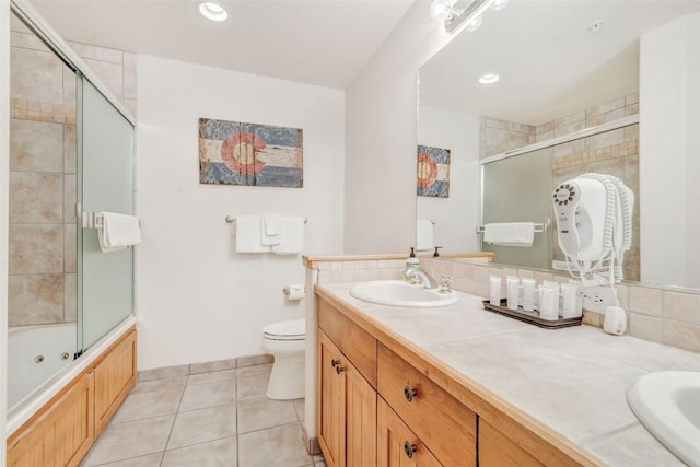 full bathroom with tile patterned flooring, vanity, toilet, and combined bath / shower with glass door