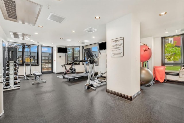 exercise room featuring floor to ceiling windows