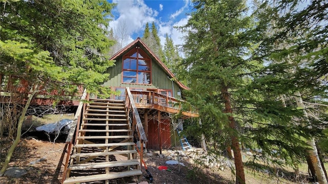 back of property featuring a wooden deck