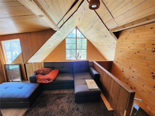 additional living space featuring hardwood / wood-style flooring, lofted ceiling, wood walls, and wood ceiling