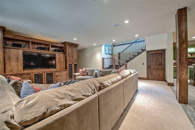 living room with recessed lighting, light colored carpet, stairs, and baseboards