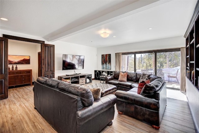 living room with beamed ceiling and light hardwood / wood-style flooring