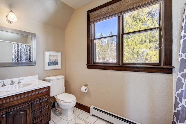 bathroom featuring vanity, tile patterned floors, vaulted ceiling, toilet, and baseboard heating