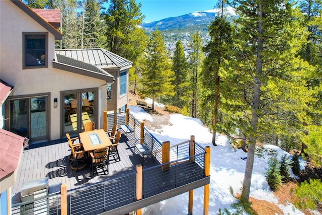 snow covered deck featuring a mountain view