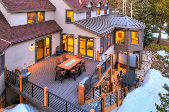 snow covered house featuring a wooden deck