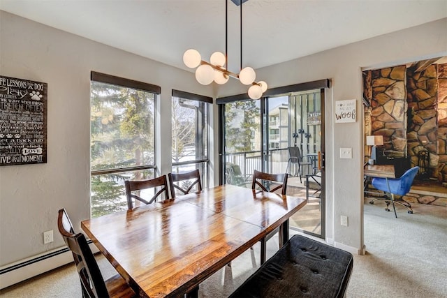 dining space with a baseboard heating unit, carpet floors, and a chandelier