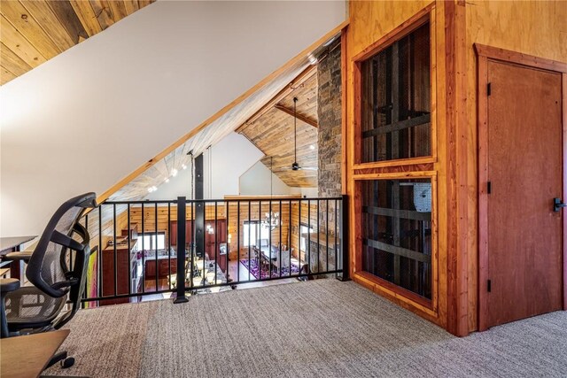 interior space with ceiling fan, lofted ceiling with beams, wood ceiling, and carpet floors