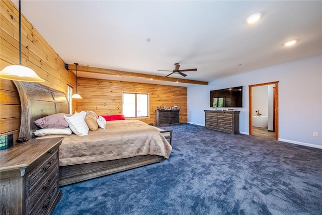 bedroom with beamed ceiling, dark carpet, ceiling fan, and wood walls