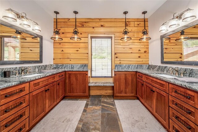 bathroom featuring wood walls and vanity