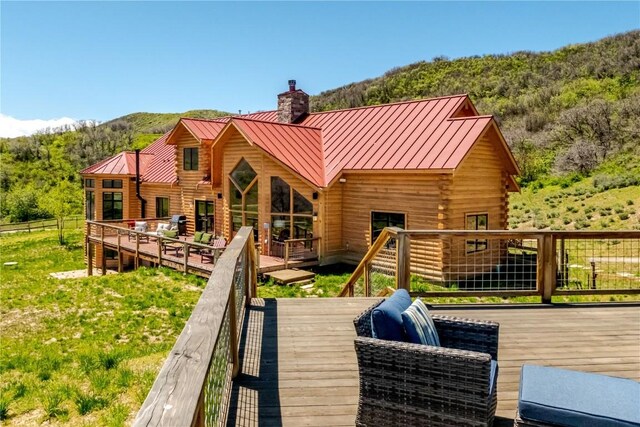 rear view of house featuring a deck