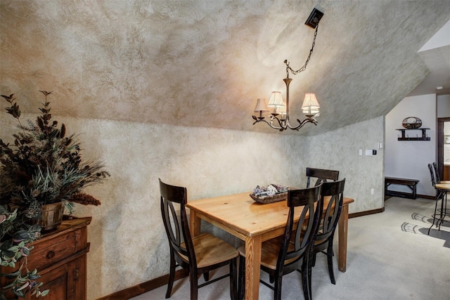 dining area with a chandelier, light colored carpet, vaulted ceiling, and baseboards