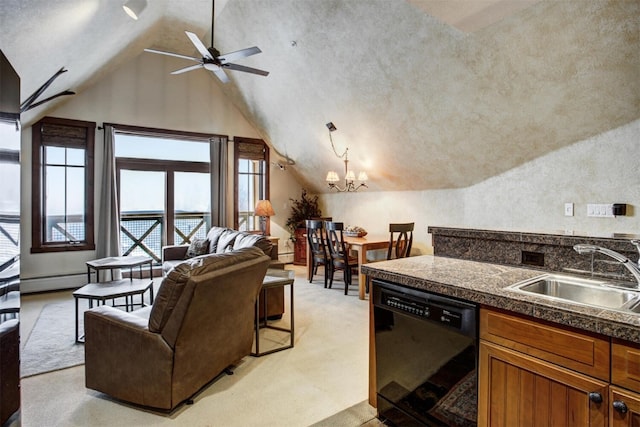 kitchen with a sink, black dishwasher, vaulted ceiling, open floor plan, and tile counters