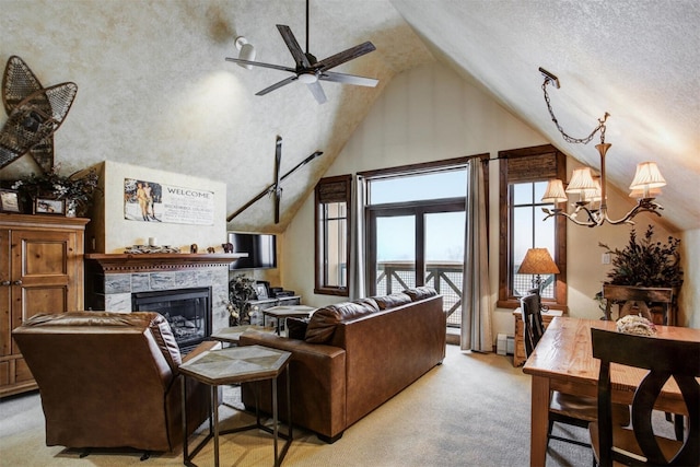 living area featuring a ceiling fan, a tiled fireplace, light colored carpet, a textured ceiling, and high vaulted ceiling