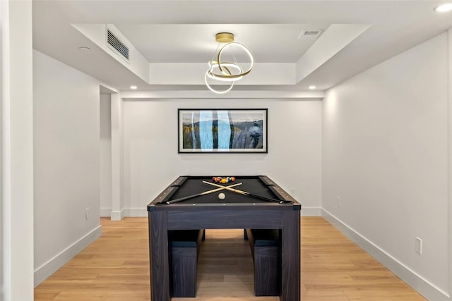 recreation room featuring light wood-style flooring, baseboards, a raised ceiling, and pool table